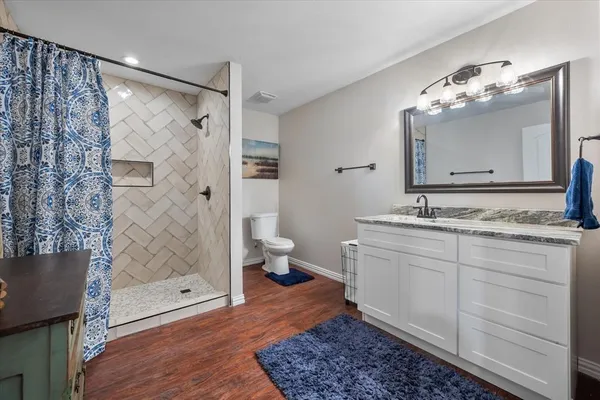 a bathroom with a double vanity sink mirror and shower
