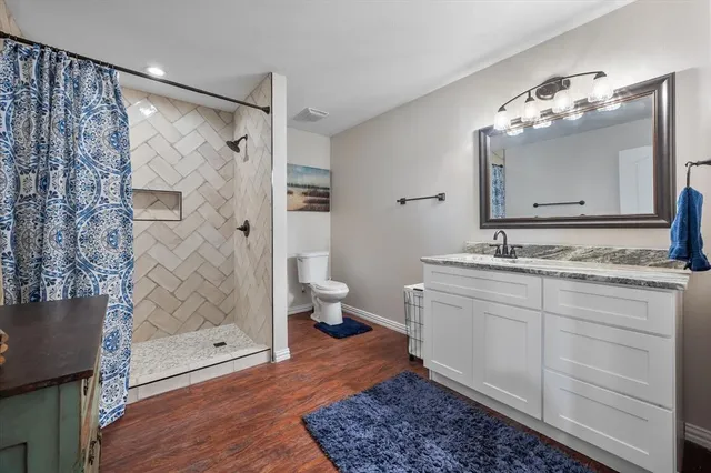 a bathroom with a double vanity sink mirror and shower