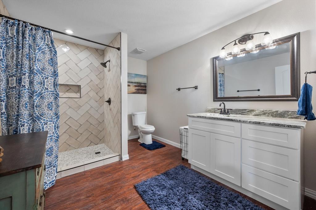 226 Palisade Loop Mabank, TX 75156 - Photo 26 of 40 a bathroom with a double vanity sink mirror and shower