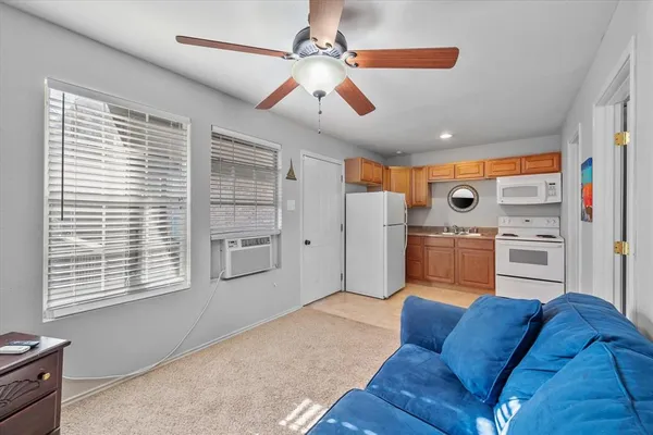 a living room with furniture and kitchen view