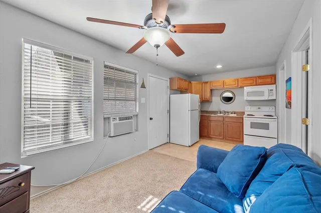 a living room with furniture and kitchen view
