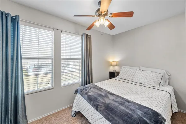 a bedroom with a large bed and a chandelier
