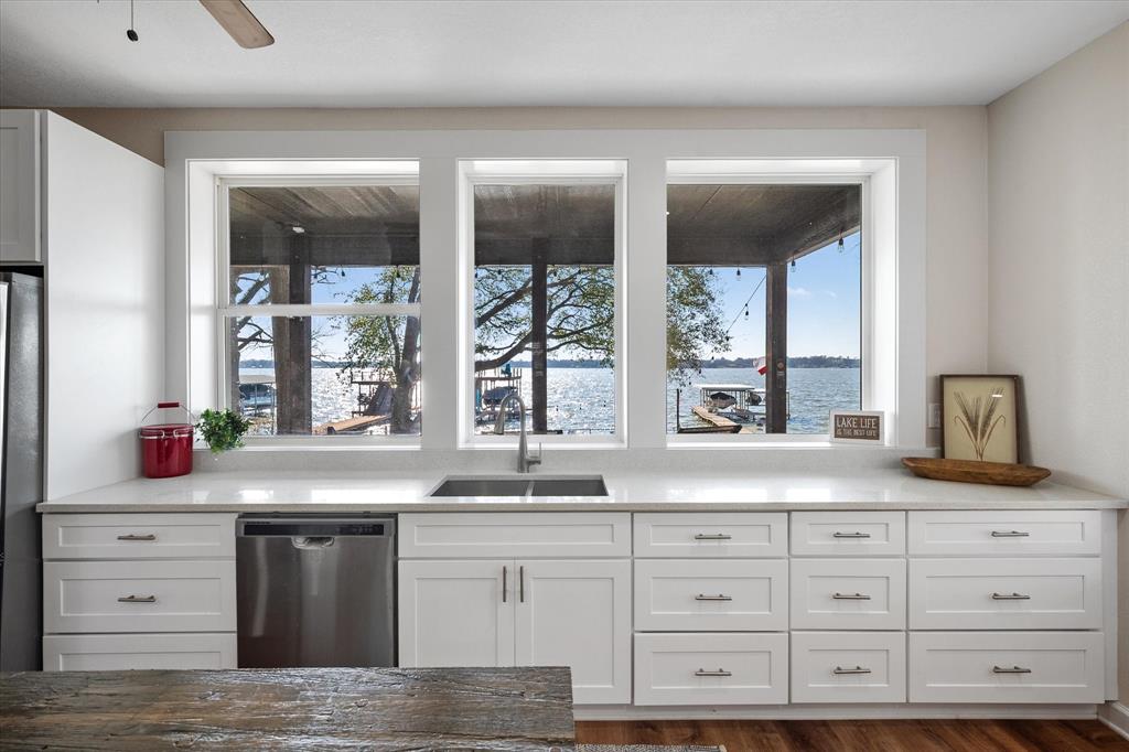 226 Palisade Loop Mabank, TX 75156 - Photo 7 of 40 a kitchen with granite countertop a sink window and cabinets
