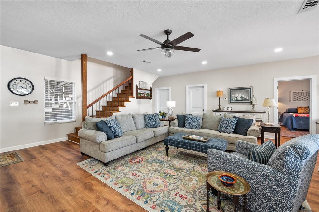 226 Palisade Loop Mabank, TX 75156 - Photo 10 of 40 a living room with furniture ceiling fan and a rug