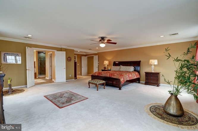 163 Sharon Station Road Robbinsville, NJ 08691 - Photo 34 of 38 a bedroom with furniture and a chandelier