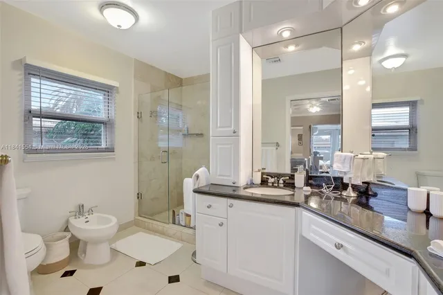 a bathroom with a sink mirror and toilet