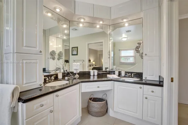 a bathroom with a sink double vanity and a mirror