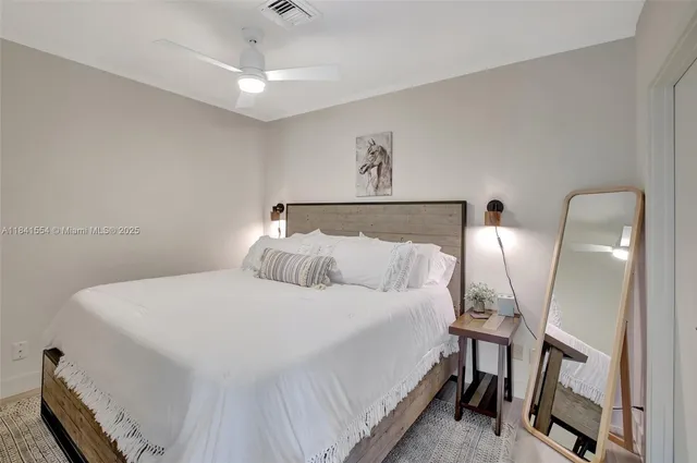 a bedroom with a bed and a mirror