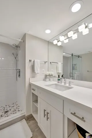 a bathroom with a sink double vanity and shower