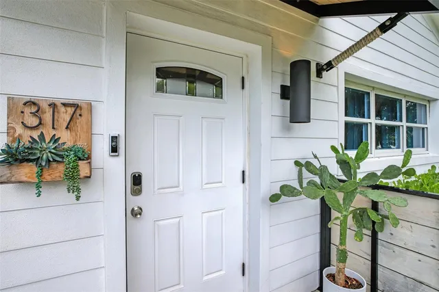 a white vase with white and yellow flowers