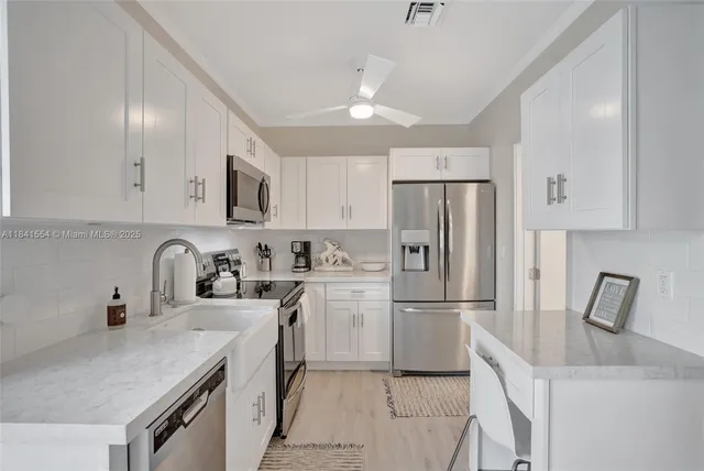 a kitchen with refrigerator cabinets and a sink