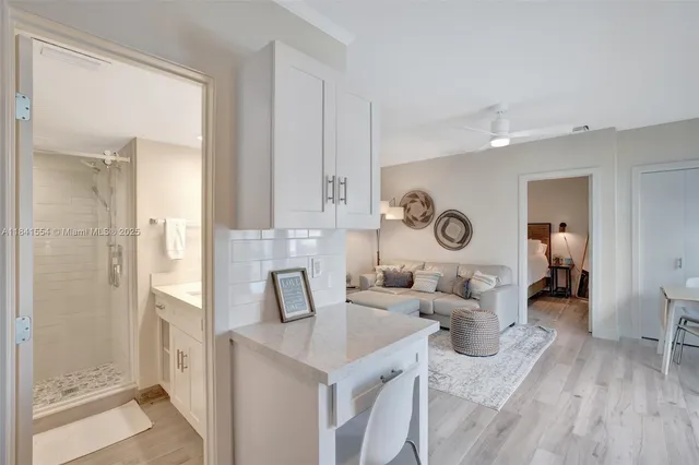 a view of a kitchen area with furniture and wooden floor