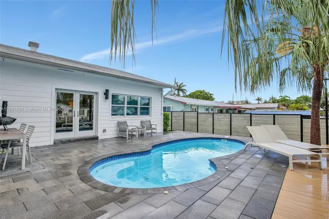 a swimming pool with outdoor seating