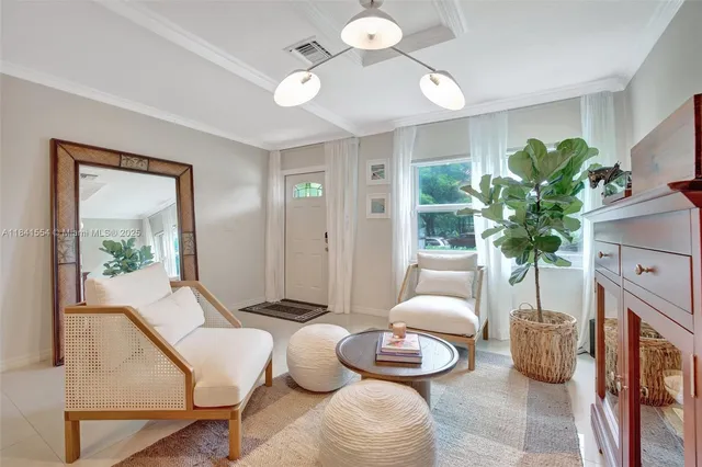 a living room with furniture and a potted plant