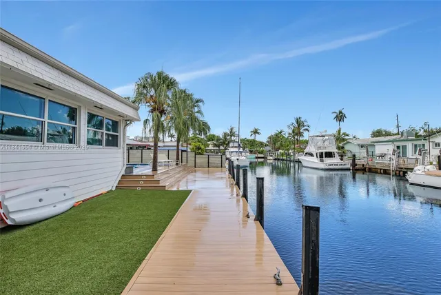 a view of a lake with boats and palm trees