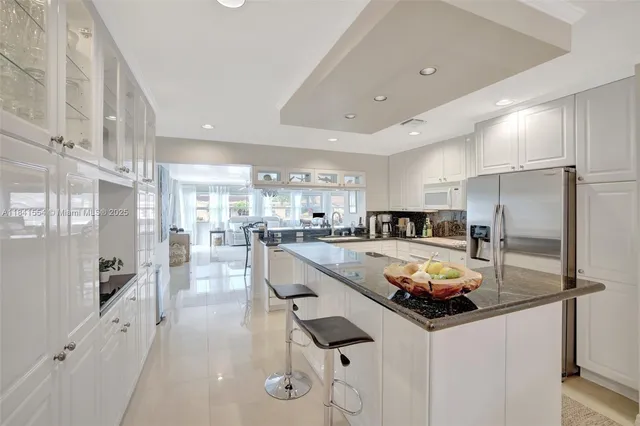 a kitchen with counter top space a sink appliances and cabinets