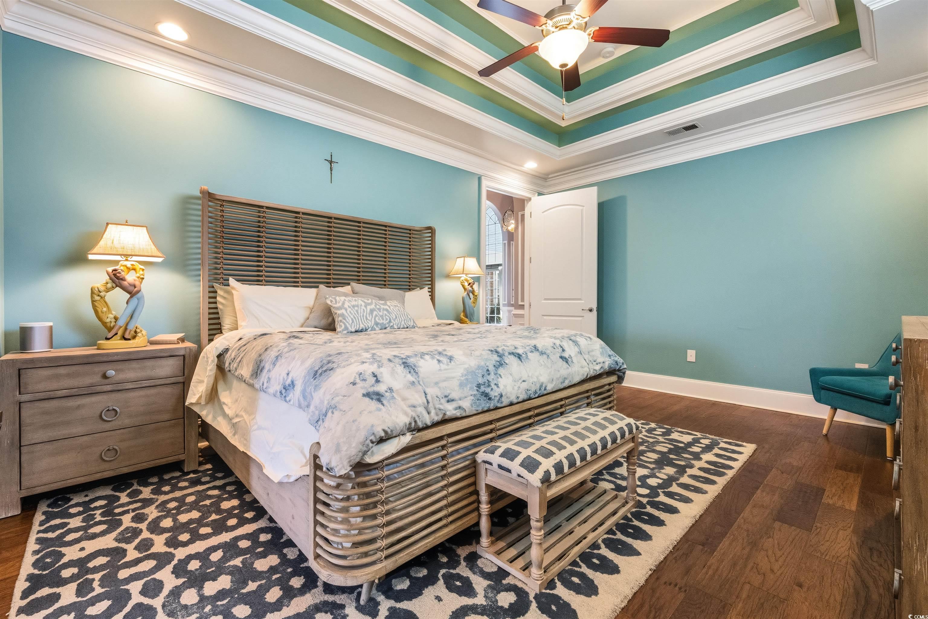2073 Timmerman Road Myrtle Beach, SC 29588 - Photo 12 of 34 Bedroom featuring a raised ceiling, crown molding, dark wood-style flooring, ceiling fan, and recessed lighting