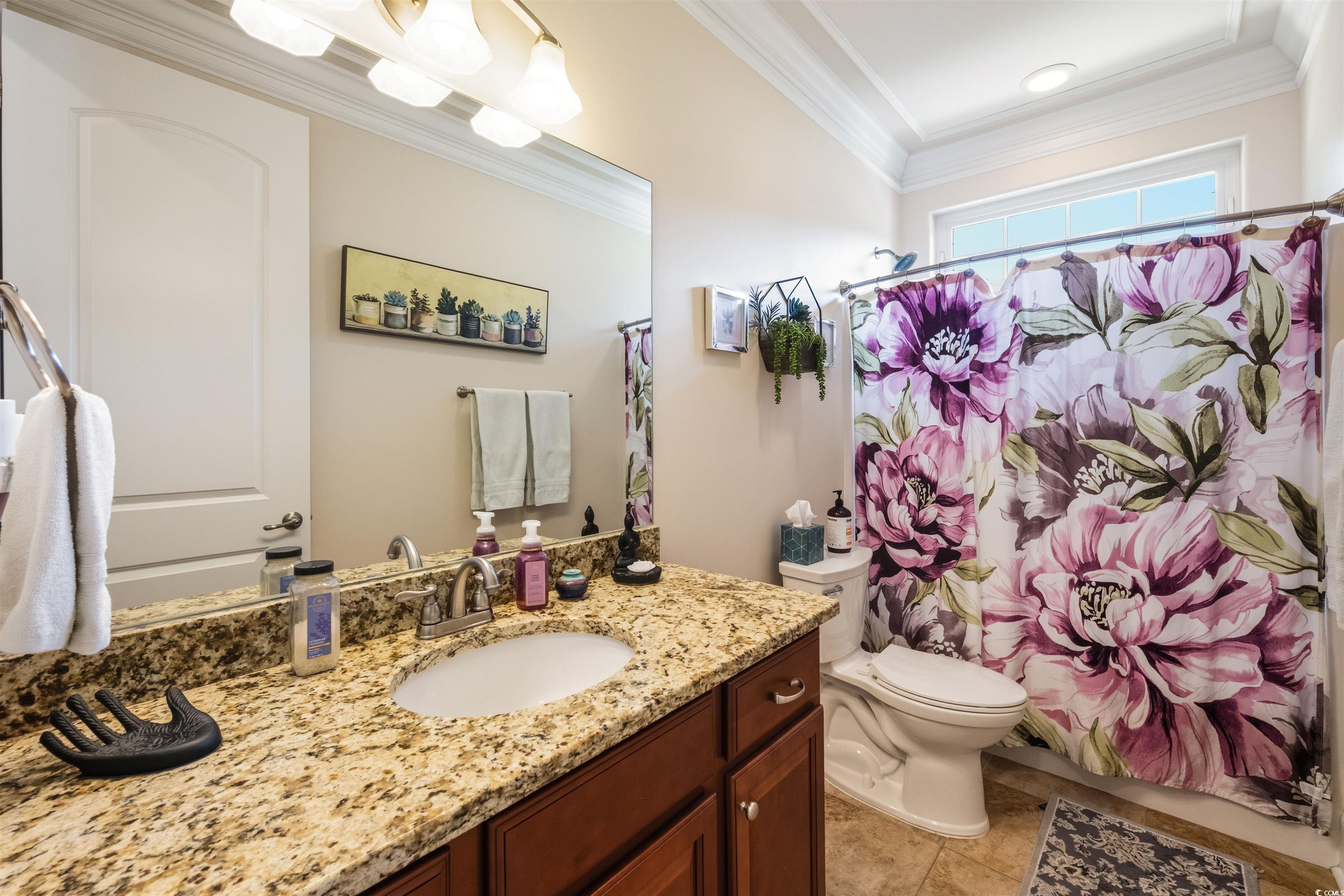 2073 Timmerman Road Myrtle Beach, SC 29588 - Photo 16 of 34 Bathroom with vanity, ornamental molding, light tile patterned floors, and shower / tub combo with curtain