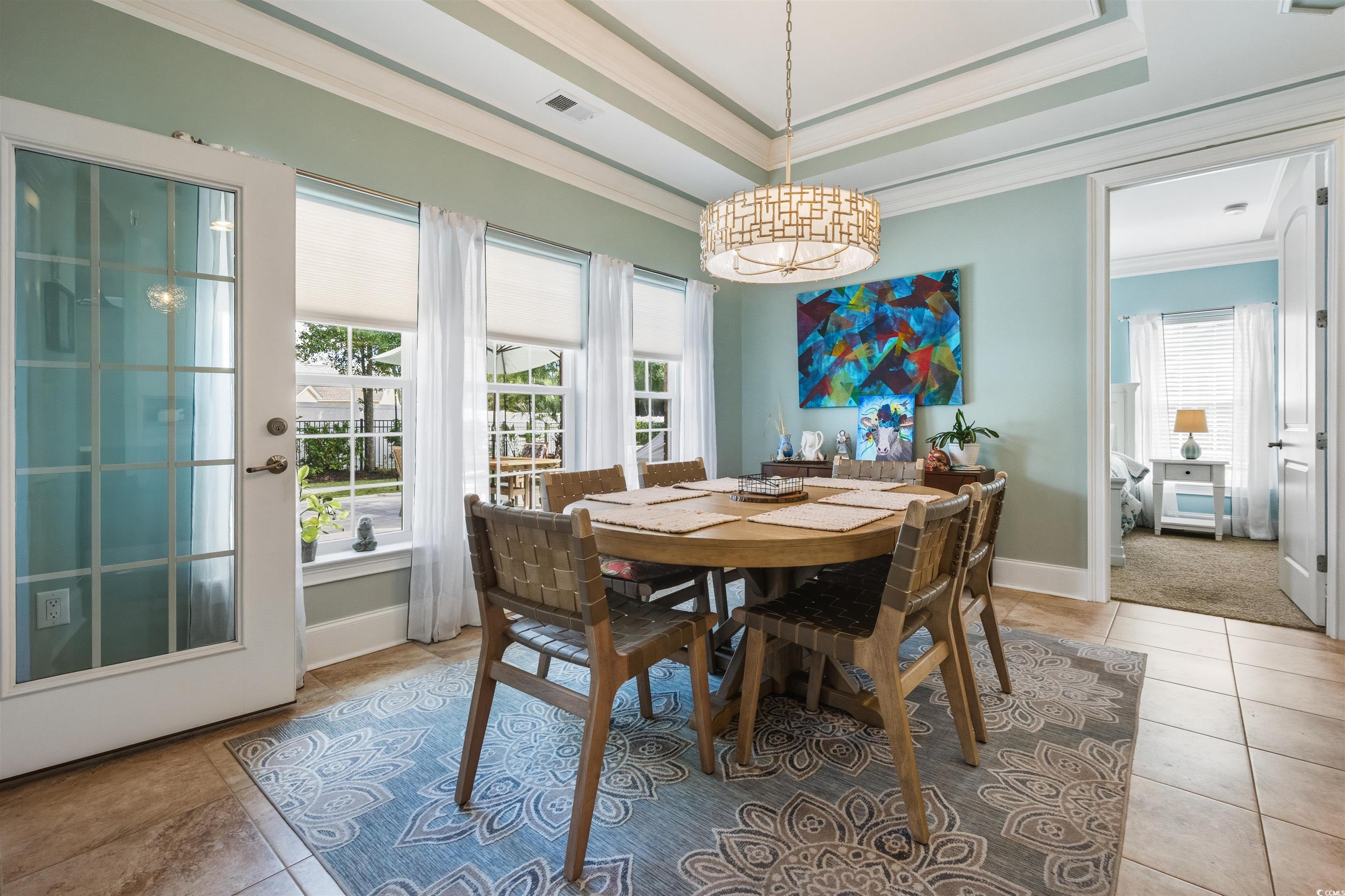 2073 Timmerman Road Myrtle Beach, SC 29588 - Photo 9 of 34 Breakfast Nook featuring ornamental molding, a tray ceiling, and light tile patterned floors