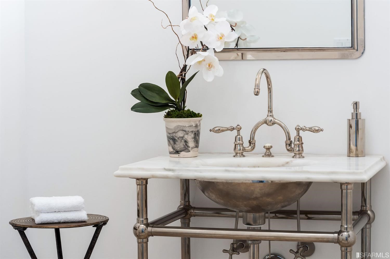 135 Sea Cliff Avenue San Francisco, CA 94121 - Photo 24 of 69 a table with a vase and flowers on it