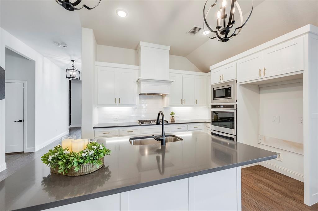 14304 Spitfire Trail Fort Worth, TX 76262 - Photo 11 of 31 a kitchen with kitchen island stainless steel appliances a sink stove and cabinets