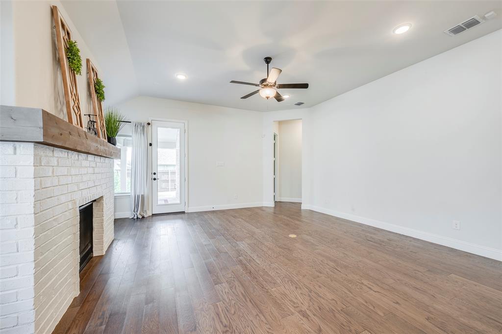 14304 Spitfire Trail Fort Worth, TX 76262 - Photo 15 of 31 a view of empty room with wooden floor and fireplace