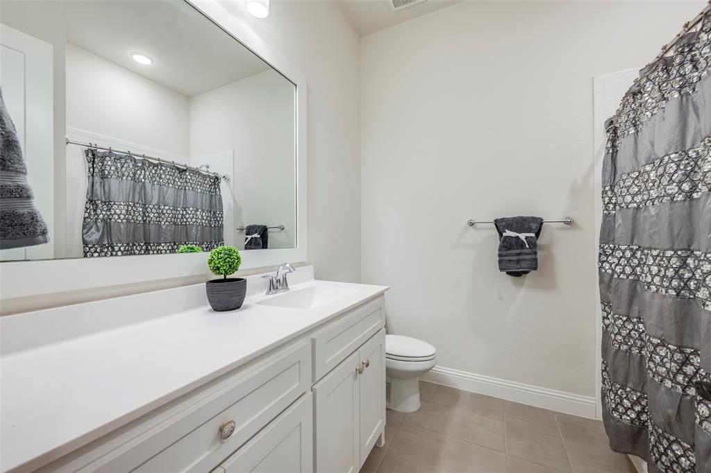 14304 Spitfire Trail Fort Worth, TX 76262 - Photo 17 of 31 a bathroom with a granite countertop sink and a mirror