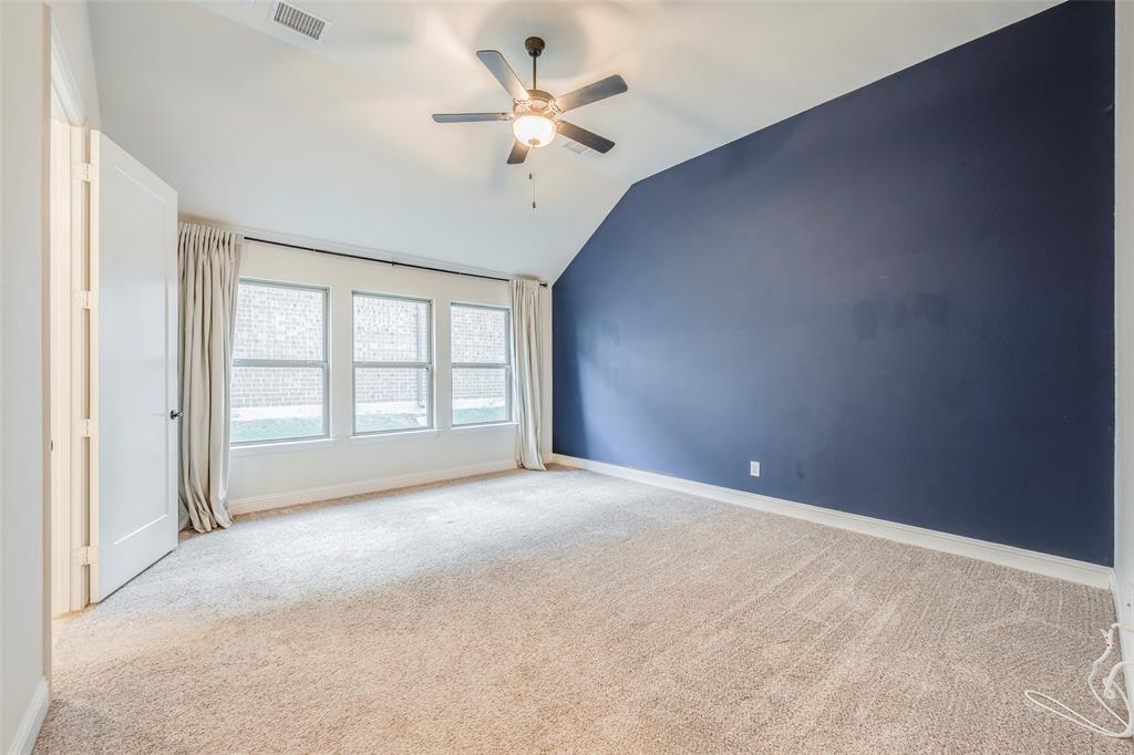 14304 Spitfire Trail Fort Worth, TX 76262 - Photo 22 of 31 an empty room with windows and ceiling fan