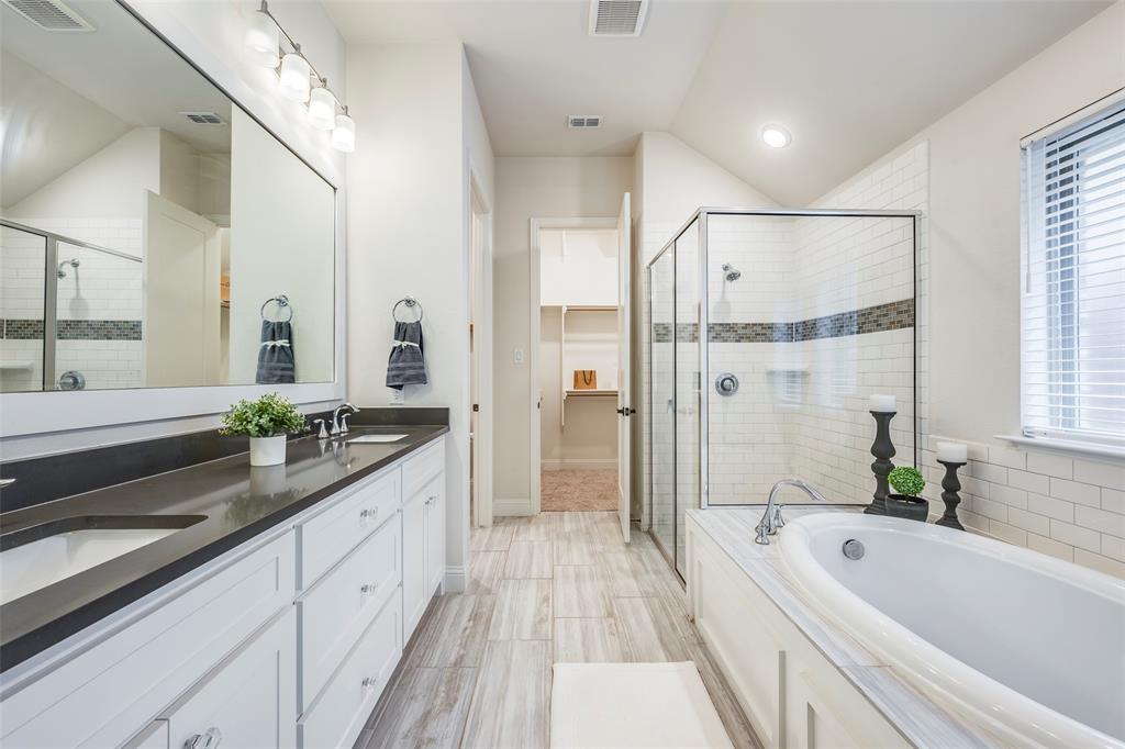 14304 Spitfire Trail Fort Worth, TX 76262 - Photo 24 of 31 a spacious bathroom with a double vanity sink a mirror a bathtub and shower
