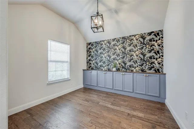 a dining room with furniture a chandelier and wooden floor
