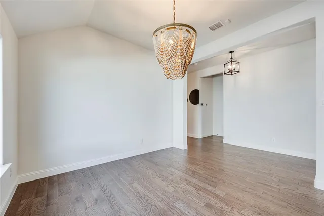 a kitchen with stainless steel appliances granite countertop a sink a stove and cabinets