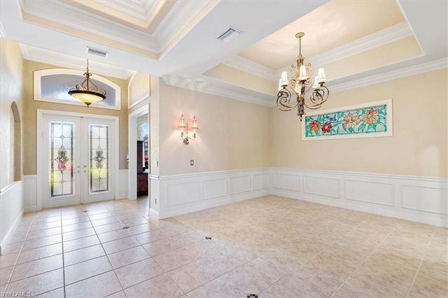 a view of a hallway with a chandelier