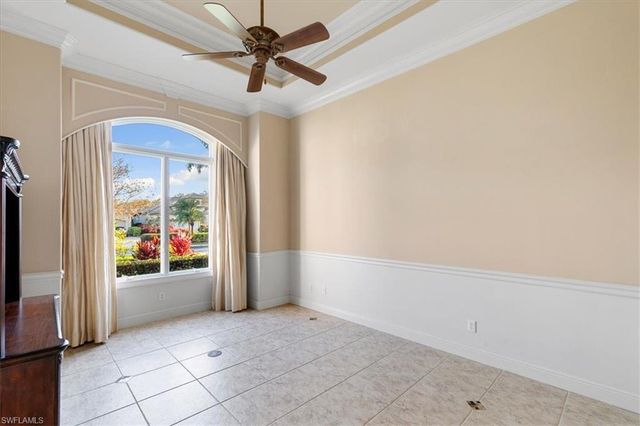a view of a hallway with wooden cabinets