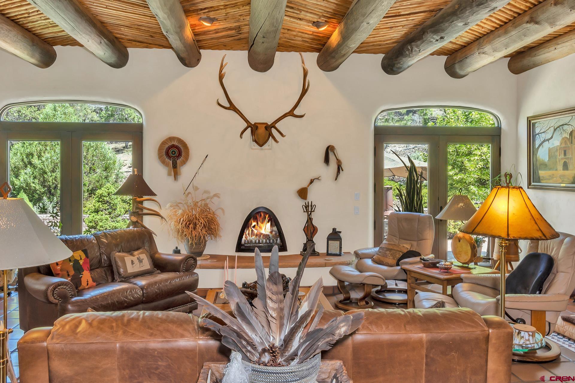 2000 Castle Peak Ranch Road Eagle, CO 81631 - Photo 23 of 35 a living room with furniture a fireplace and a chandelier