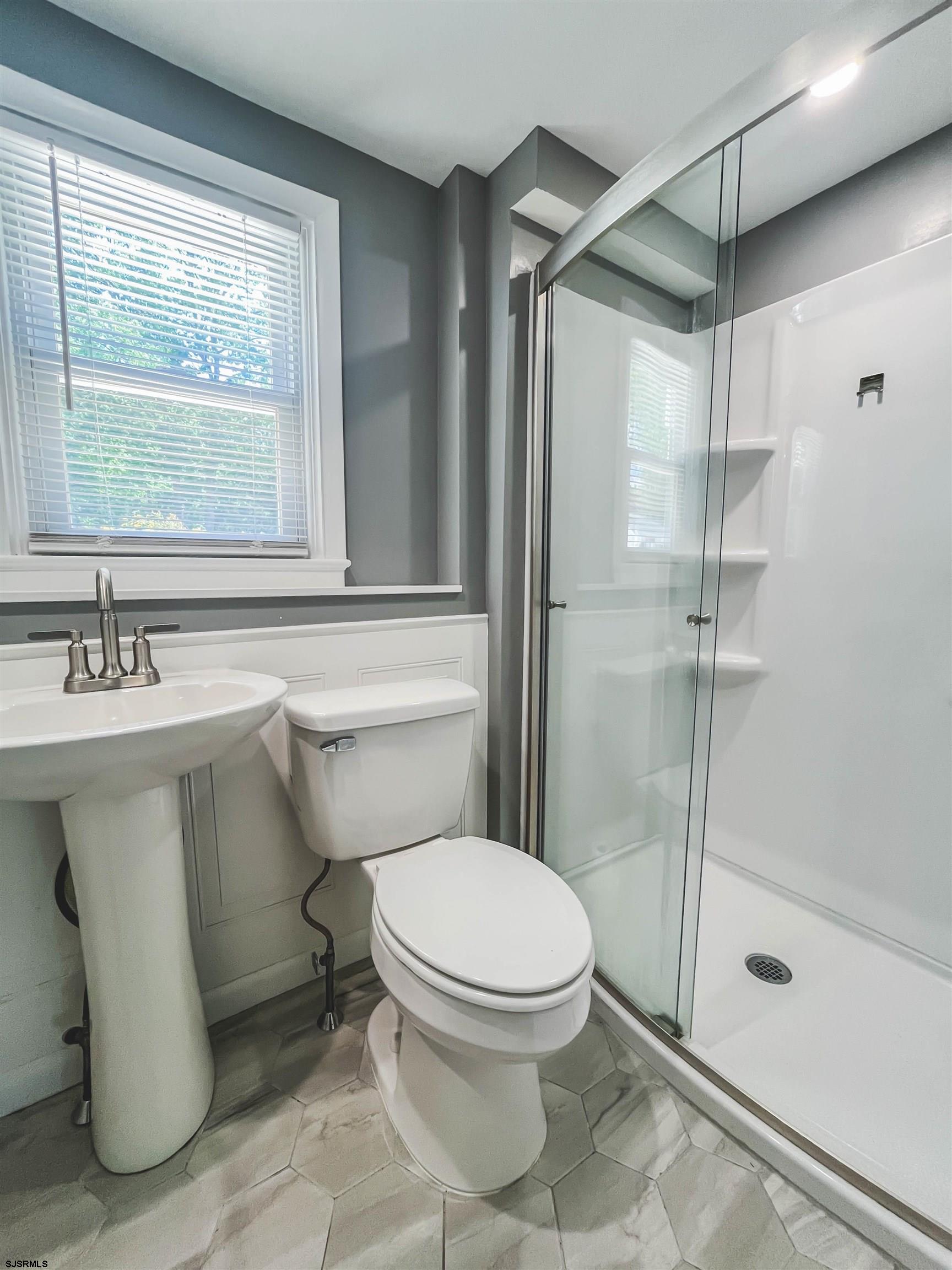 518 Delaware Avenue Absecon, NJ 08201 - Photo 12 of 38 a bathroom with a sink toilet and shower