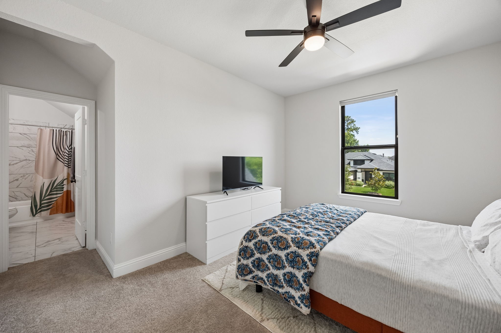 10102 South Goshawk Trail Conroe, TX 77385 - Photo 20 of 46 a bedroom with a bed and a tv