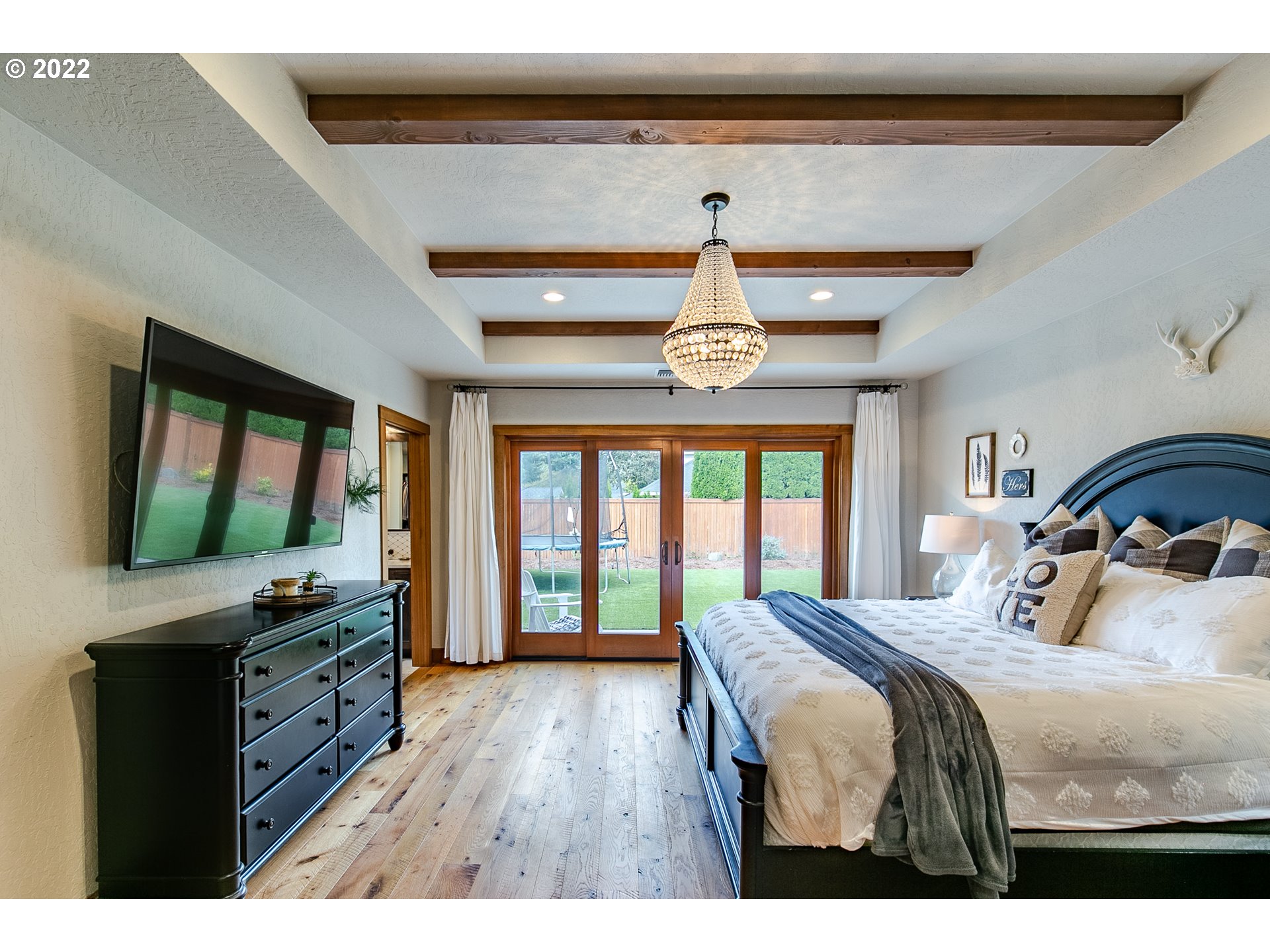 2115 Bedford Way Eugene, OR 97401 - Photo 17 of 32 a bedroom with a bed and a flat tv screen on dresser