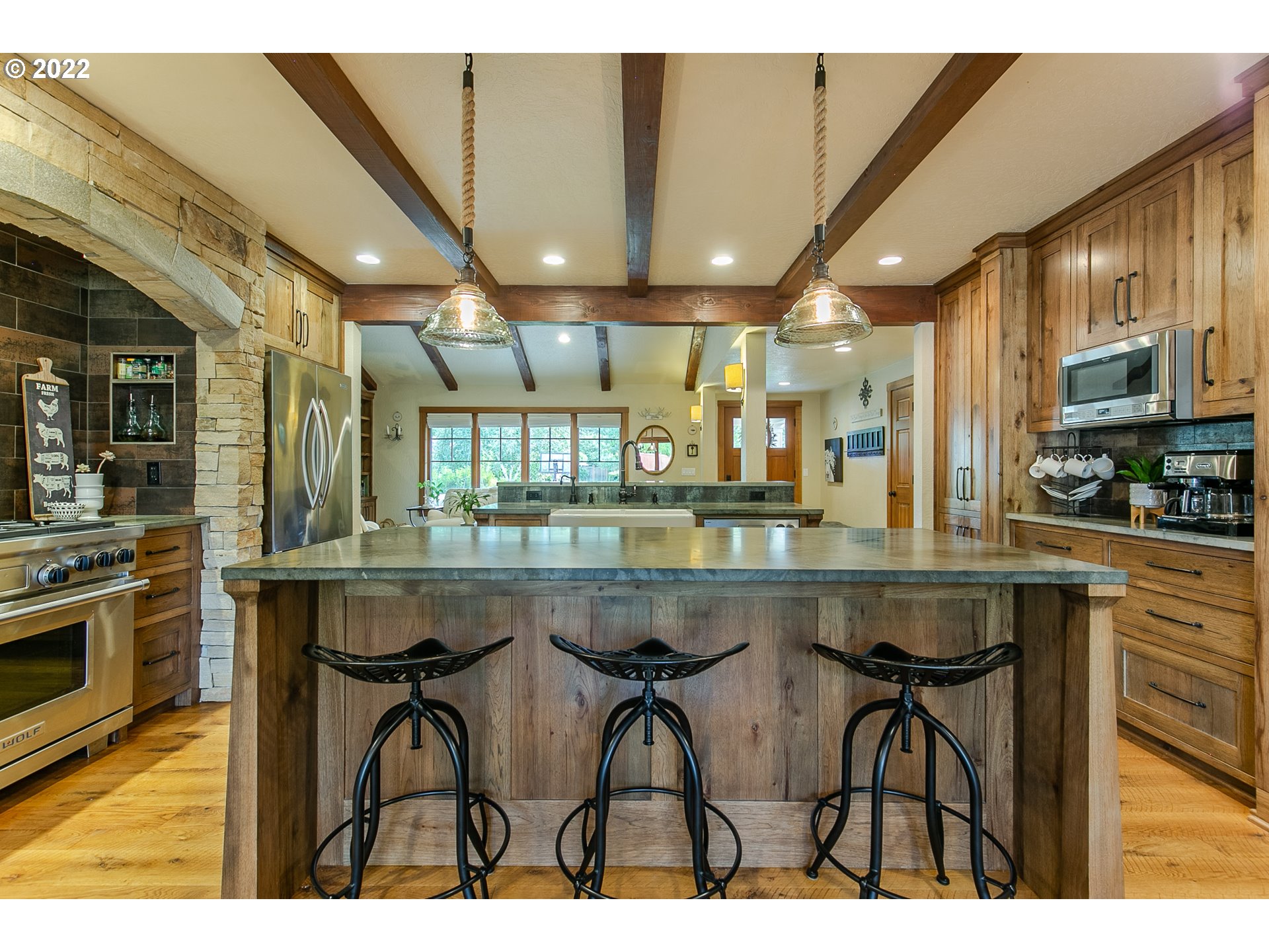 2115 Bedford Way Eugene, OR 97401 - Photo 7 of 32 a kitchen with stainless steel appliances granite countertop table chairs and wooden cabinets