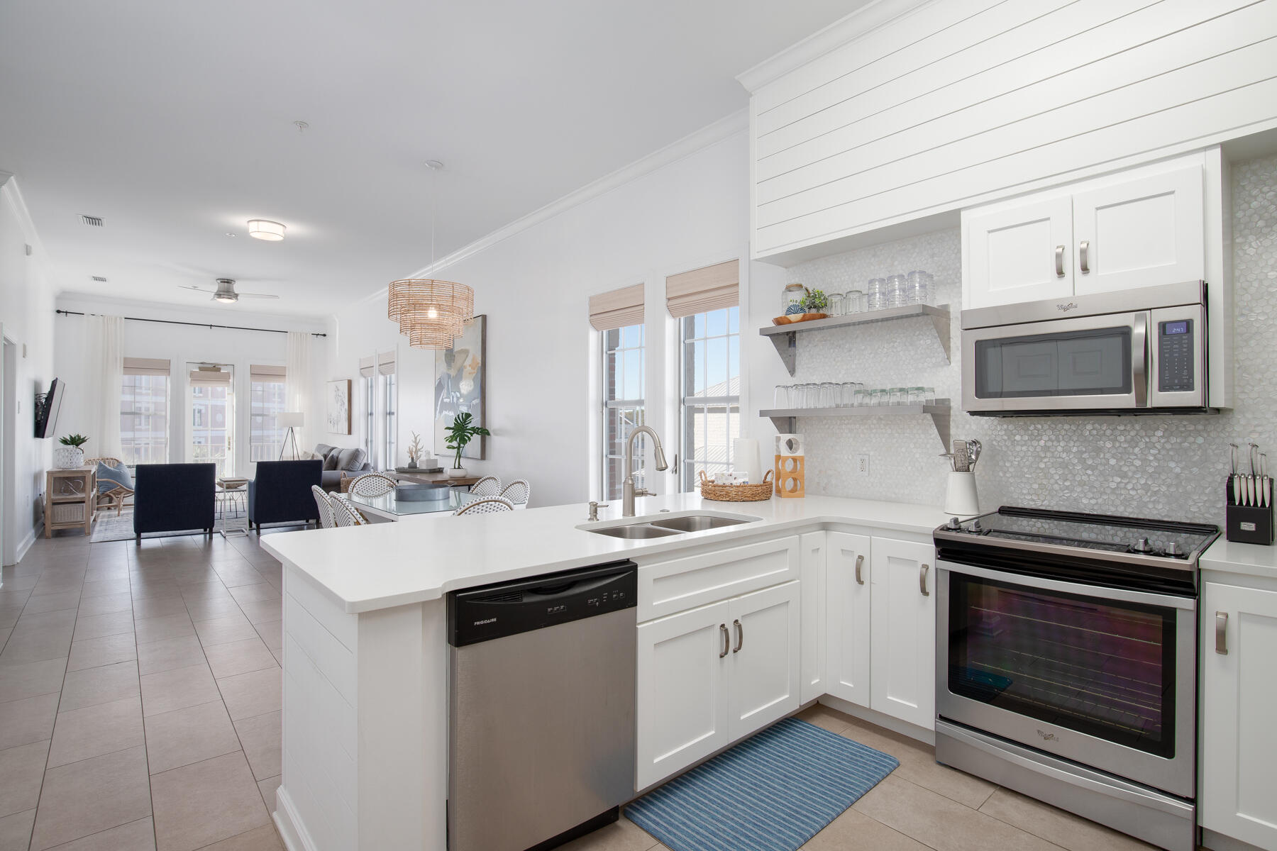 a kitchen with a sink a stove and cabinets