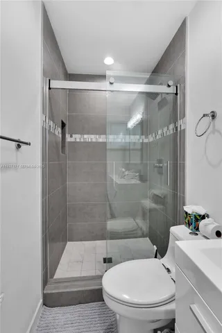 a bathroom with a toilet and a shower