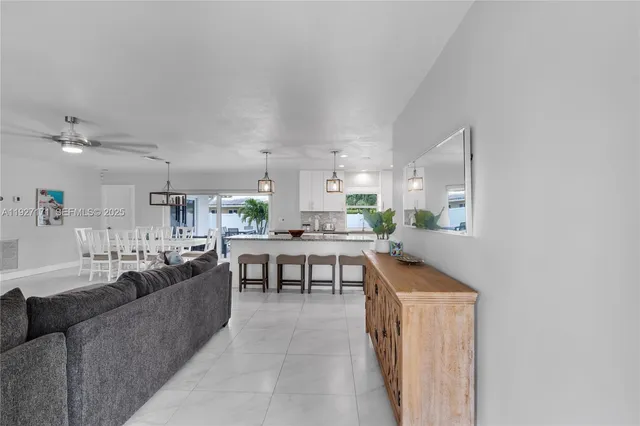 a living room with stainless steel appliances kitchen island granite countertop furniture and a view of kitchen