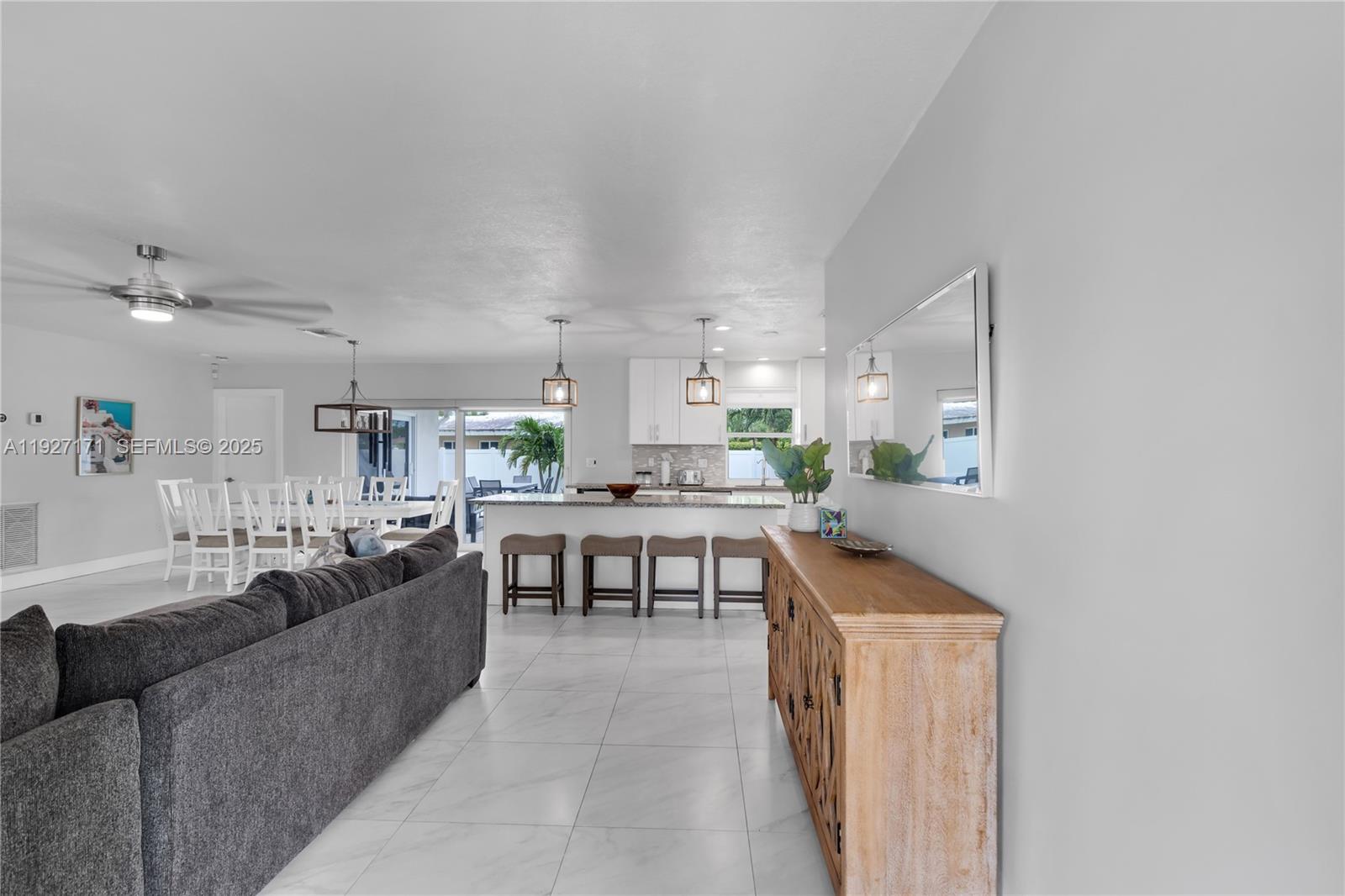 251 Southeast 8th Street Pompano Beach, FL 33060 - Photo 2 of 34 a living room with stainless steel appliances kitchen island granite countertop furniture and a view of kitchen
