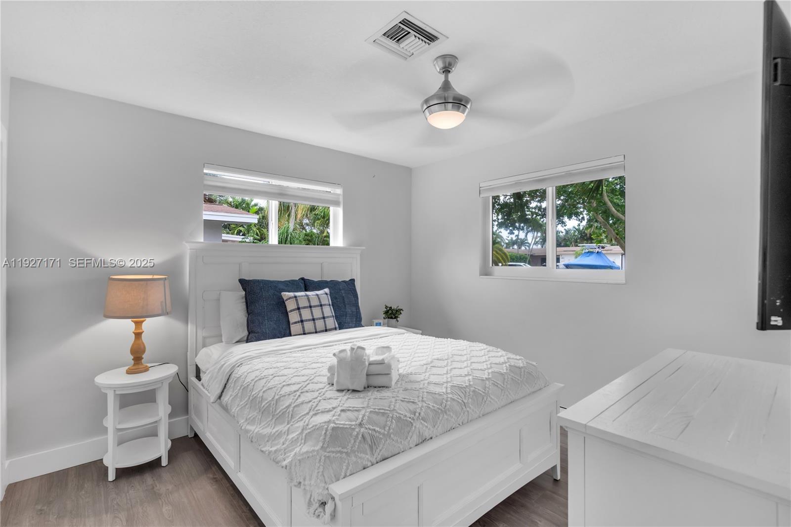 251 Southeast 8th Street Pompano Beach, FL 33060 - Photo 21 of 34 a bedroom with a bed and a table