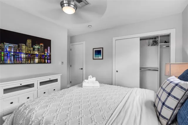 a bedroom with a bed and a book shelf