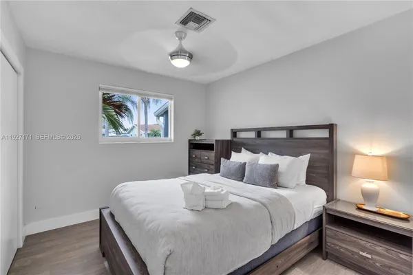 a bedroom with a bed and a night stand