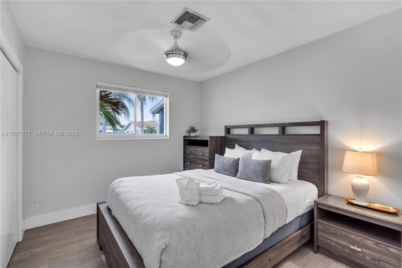 251 Southeast 8th Street Pompano Beach, FL 33060 - Photo 23 of 34 a bedroom with a bed and a night stand