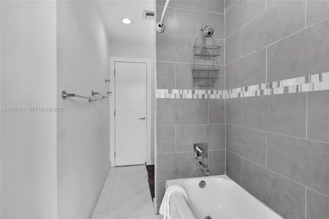 a bathroom with a bathtub and shower