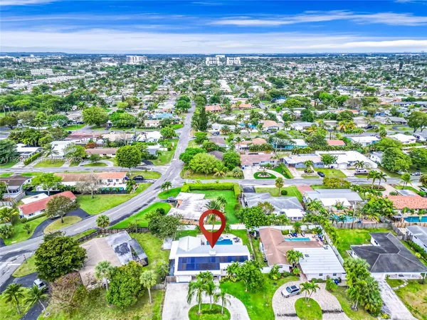 an aerial view of residential houses with outdoor space and street view
