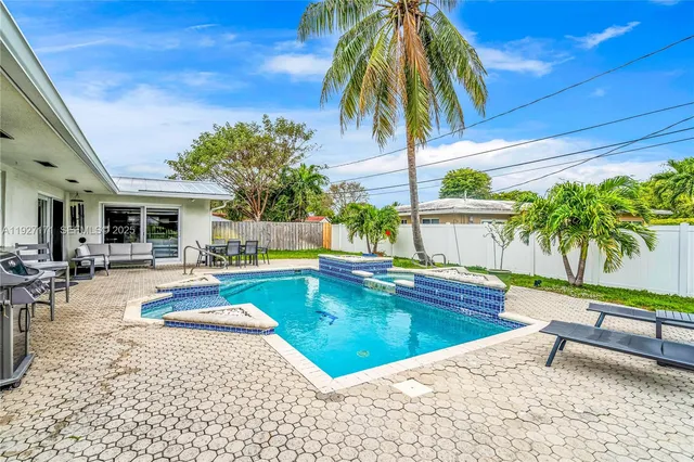 a swimming pool with outdoor seating yard and barbeque oven