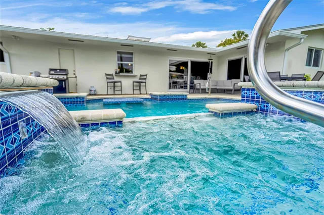 a view of living room kitchen with furniture and flat screen tv